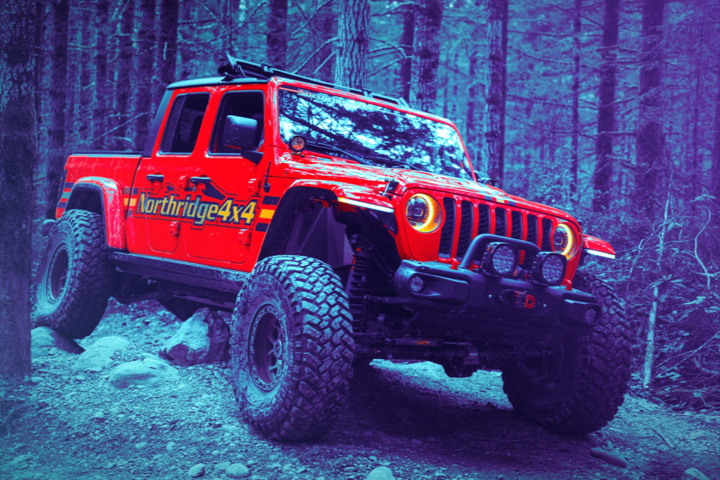 Northridge4x4 red Jeep Gladiator crawling over rocks on a forest trail
